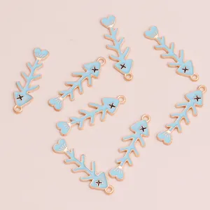 Light blue enamel fishbone charms with golden alloy base for DIY jewelry making