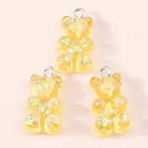 Detailed view of yellow resin gummy bear charms with colorful glitter for DIY jewelry making