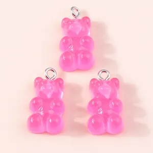 Detailed view of pink resin gummy bear charms with silver loops for jewelry making