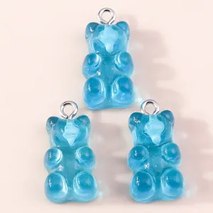 Detail view of three translucent blue resin bear pendants with silver metal loops