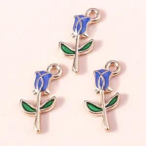 Detail of three blue enamel rose flower charms with gold alloy edges for DIY jewelry
