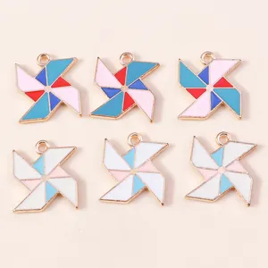 Close-up of colorful enamel windmill pendants with gold alloy edges for DIY jewelry crafts