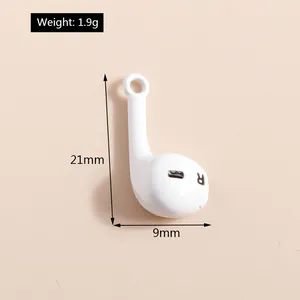 Detailed view of white headphone charm pendant with R mark and 21mm by 9mm dimensions