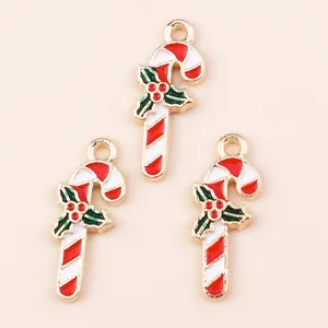 Christmas candy cane charms with red white stripes and holly leaf detail for DIY crafts