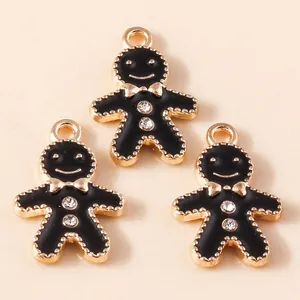 Cute gingerbread man pendants with black enamel and rhinestones on gold alloy base