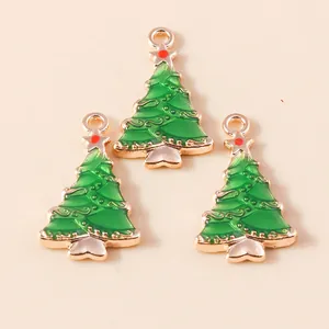 Close-up of green enamel Christmas tree charms with gold plating and hanging loops