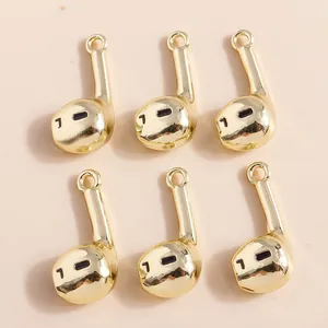 Macro shot of six gold-plated headphone charms with top rings for DIY jewelry