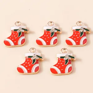 Five gold enamel Christmas stocking charms with red, white and green rhinestone accents