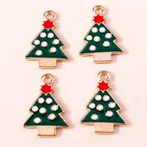 Set of four green enamel Christmas tree alloy charms with red stars and white polka dots