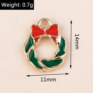 Macro detail of Christmas wreath pendant with red bow and green enamel finish