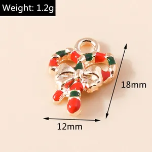 Macro detail of Christmas candy cane charm with red enamel, gold bow, and 12mm x 18mm size specs