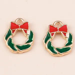 Detail of Christmas wreath alloy pendants with red bows and enamel finish for DIY jewelry