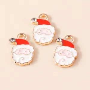 Close-up of enamel Santa Claus pendants with red hats and rhinestones for DIY jewelry
