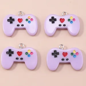 Set of four lavender resin game controller pendants with colorful buttons and metal rings