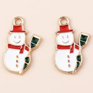 Detail view of cute enamel snowman charms with red hats for Christmas DIY jewelry