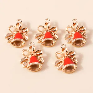 Detail view of 5-piece gold and red enamel Christmas bell pendants with bow accents