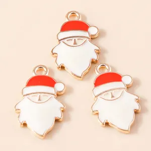 Detail of red and white Santa Claus enamel alloy charms for DIY holiday jewelry making