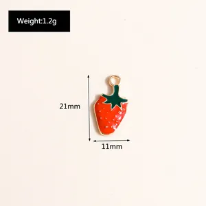 Detailed size view of strawberry charm pendant with gold loops and red enamel finish
