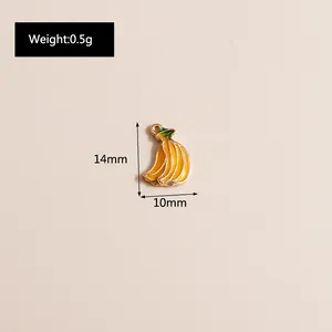 Macro detail of enamel banana charm with size markings showing 14mm height and 10mm width