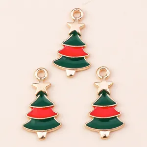 Macro detail of three enamel Christmas tree pendants with gold stars for DIY jewelry