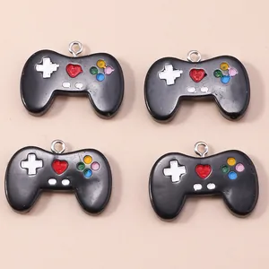 Close-up of four black game controller acrylic charms with colorful buttons for DIY jewelry