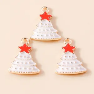 Detailed view of white enamel Christmas tree pendants with gold edges and red star tops