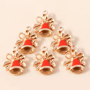 Golden Christmas bell charms with red enamel bows for DIY holiday jewelry making
