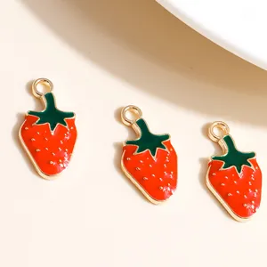 Detailed macro view of red enamel strawberry charms with gold-plated metal alloy rims