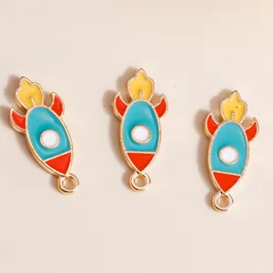 Macro shot of three colorful cartoon rocket enamel alloy charms for DIY jewelry making