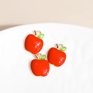 Three red apple charm pendants with green leaf and gold trim for DIY jewelry making