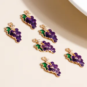 Detailed view of purple grape charms with gold alloy frame and green leaves for DIY crafts