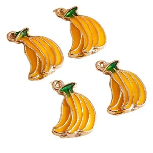 Set of 4 yellow enamel banana charms with green stems and gold edges for DIY jewelry crafting
