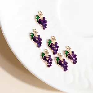 Purple grape alloy pendants for DIY jewelry making on white textured ceramic plate