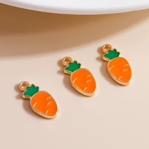 Macro detail of alloy carrot charms with orange enamel and gold metal edges for DIY jewelry