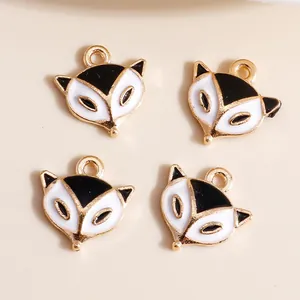 Detailed view of four black and white enamel fox pendants with gold plating for DIY jewelry