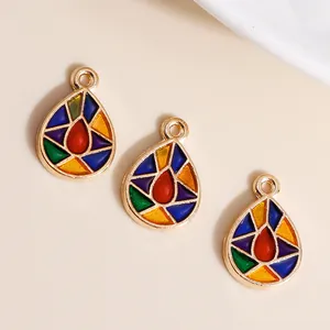 Macro view of teardrop enamel charms with colorful geometric patterns and gold alloy edges