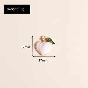 Detail view of 17mm enamel peach pendant with gold edges and green leaf ornament