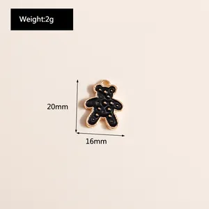 Macro shot of a black enamel bear pendant with gold metallic edges for DIY jewelry making