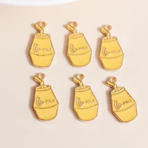 Macro shot of 6 yellow banana milk bottle charms made of alloy with gold enamel detailing