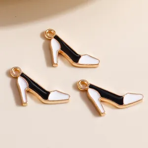 Close-up of black and white enamel high heel charms with gold-tone metal loop for DIY jewelry