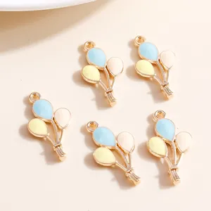 Detail of colorful balloon charms in macaron drip oil with golden alloy loops