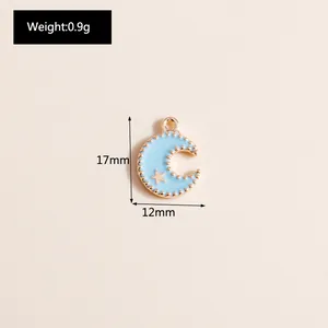 Detail view of a 17mm light blue enamel crescent moon pendant with gold bead trim