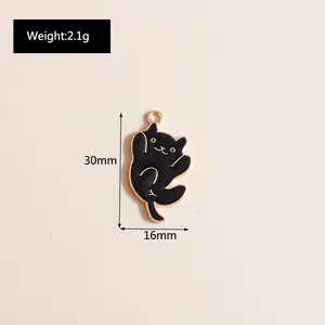 Detailed view of 30x16mm black enamel cat pendant with gold-tone metal edges and dimensions