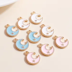 Macro detail of alloy moon pendants with enamel finish and gold star accents for DIY jewelry