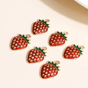Set of six red strawberry alloy pendants with gold accents for DIY jewelry making