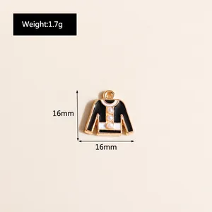 Macro detail of 16mm jacket charm with black and white enamel and faux pearls