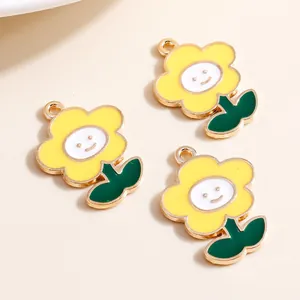 Detailed view of yellow smiley flower charms with gold edges for DIY jewelry making
