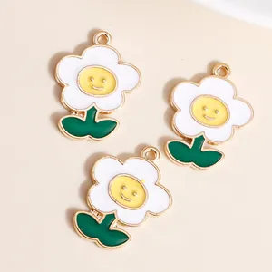 Macro detail of three enamel flower pendants with smiley faces for DIY jewelry making