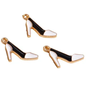 Three minimalist black and white enamel high heel charms with gold-plated metal finish