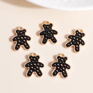 Macro shot of 5 cute bear charms with black enamel finish and gold star patterns